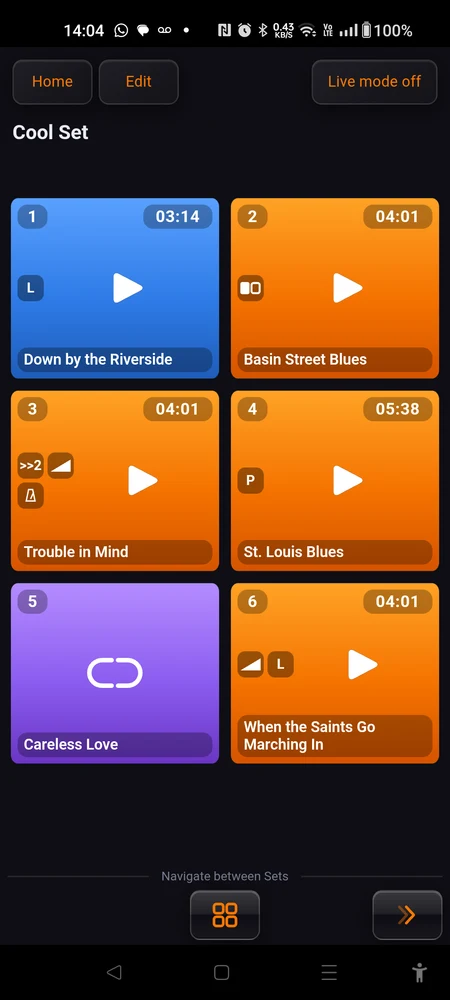 Three pads side by side: an orange one idle with badges, a blue library pad, a red one playing